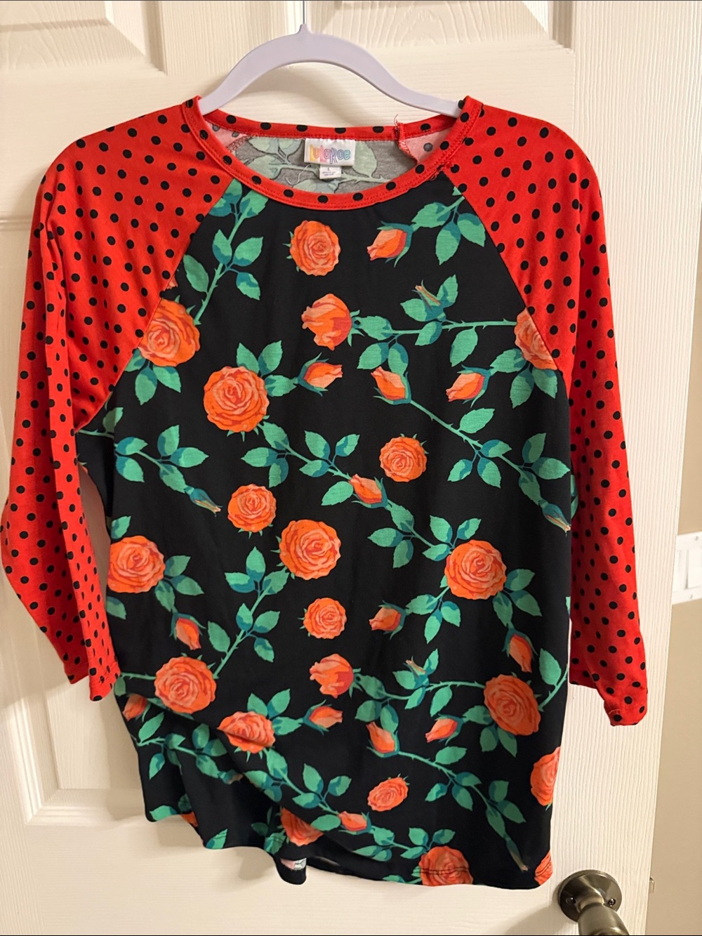 LuLaRoe Black Top with Orange Rose Print and Red Polka Dot Raglan Sleeves